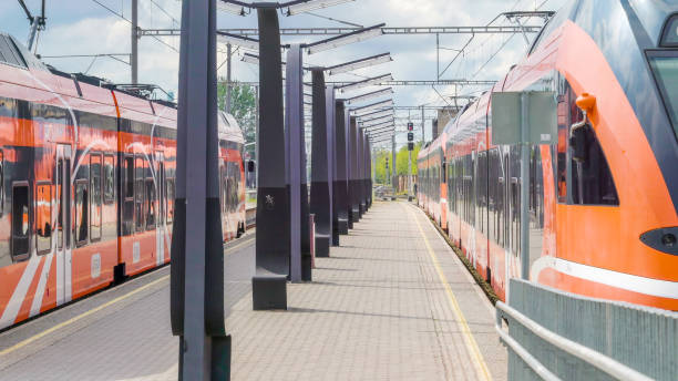 istock Two orange train on the railway stations in the city 1135720168