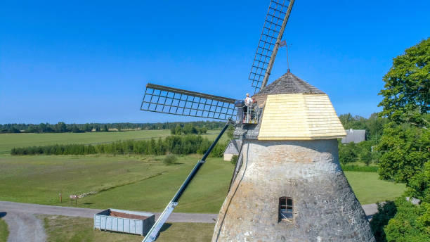 istock A man putting the wooden shingles on the windmill 1135720200