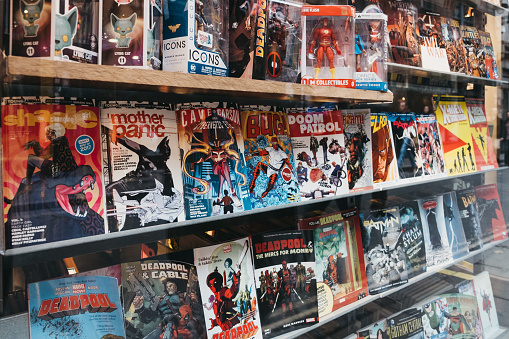 London, UK - December 18, 2018: Comic books on a window retail display of Gosh! Comics shop in Covent Garden a famous tourist area in London with lots of shops and restaurants.