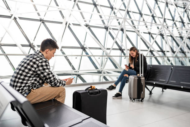 istock Young couple sitting at the airport 1135723618