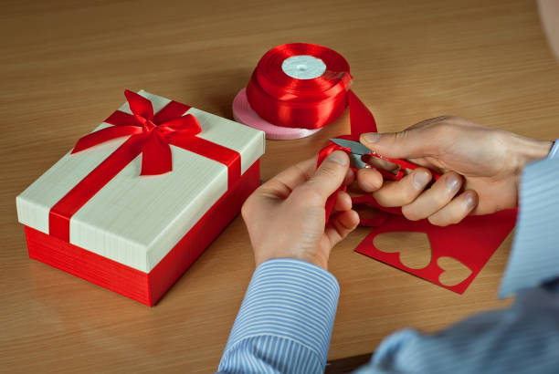 istock Gift box on the table. Box with a red ribbon and a bow. 1135723908