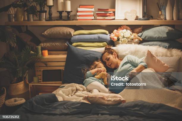 Mother Reading A Book To Her Daughter Stock Photo - Download Image Now - Storytelling, Reading, Child