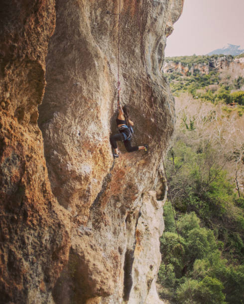 istock Girl rock climber climbs difficult route on the cliffs 1135725405