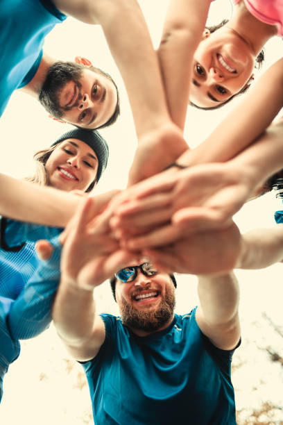 istock Team Of Smiling Athletes Motivating Each Other 1135727243