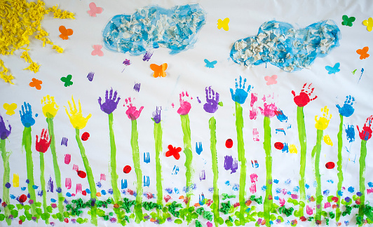 Spring mural draw over craft paper painted with hands prints. Made by nursery children