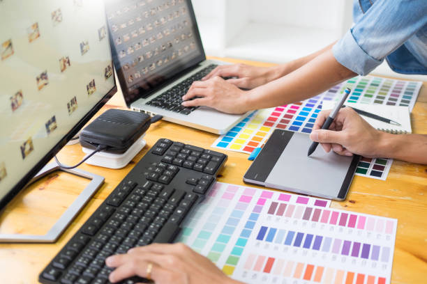 istock Cropped Hands Of Business Colleagues Using Computers At Desk In Office 1135727855