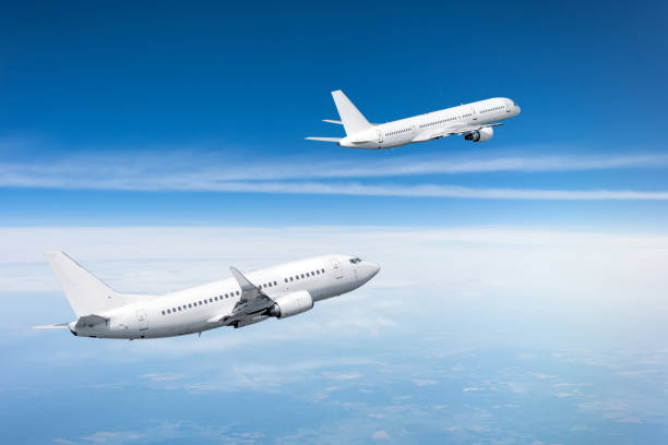 istock Two passenger aircraft gain altitude after take off. 1135729624