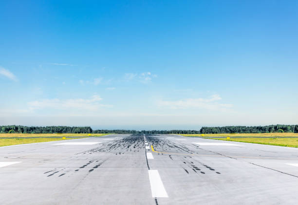 istock Empty runway at the airport on a sunny clear cloudless day. 1135729634
