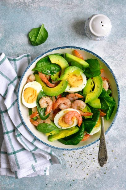 istock Avocado salad with baby spinach, shrimps and boiled eggs 1135729661