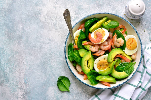 istock Avocado salad with baby spinach, shrimps and boiled eggs 1135729663