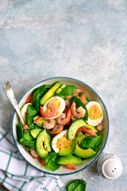 istock Avocado salad with baby spinach, shrimps and boiled eggs 1135729671