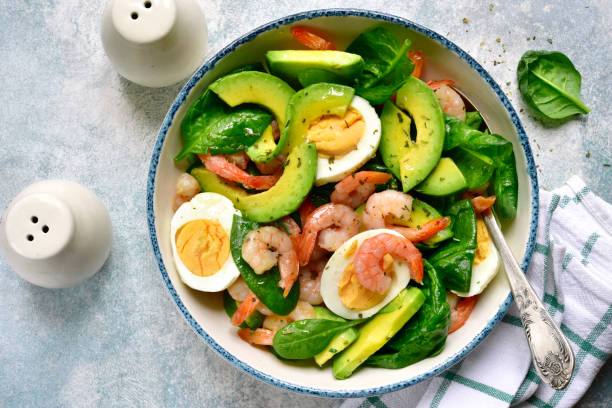 Avocado salad with baby spinach, shrimps and boiled eggs