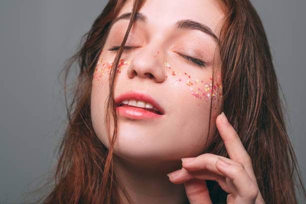 istock young beautiful female glitter makeup eyes closed 1135730138