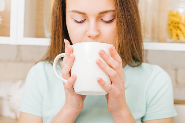 istock relaxed leisure woman enjoy hot beverage white cup 1135730216