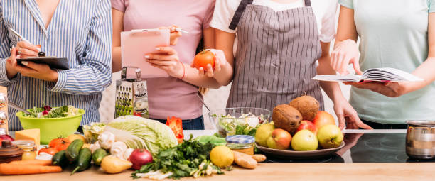 cooking class food hobby healthy eating lifestyle Cooking classes. Food preparing hobby. Group of women learning healthy eating lifestyle and balanced nutrition. cooking class photos stock pictures, royalty-free photos & images