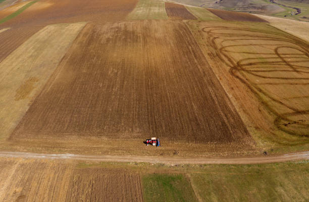 istock Aerial top view of a tractor plowing 1135731005