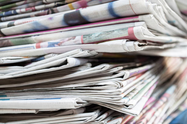 istock Newspapers folded and stacked on the table. Closeup newspaper and selective focus image. 1135731173