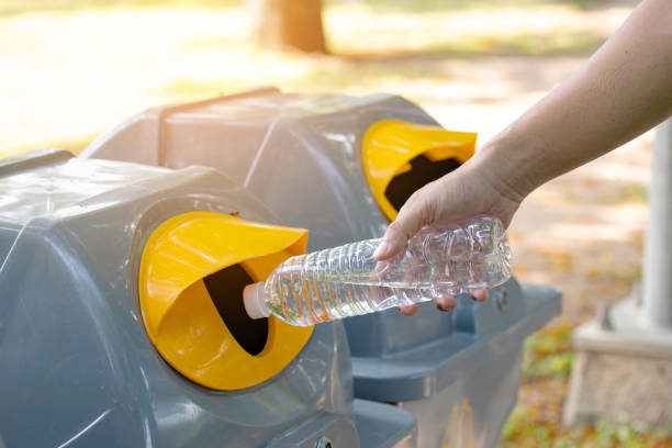 istock Closeup man hand throwing empty plastic water bottle into the trash. 1135733346