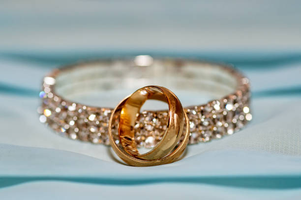 istock Close up Two wedding rings and bracelet 1135734563