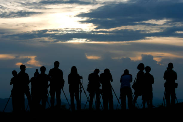 istock Silhouette People With Tripods On Land Against Cloudy Sky During Sunset 1135737304