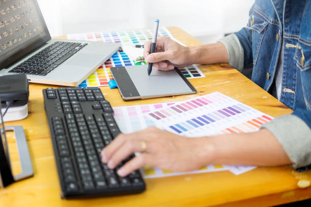 istock Midsection Of Graphic Designer Using Digital Tablet On Desk 1135739349