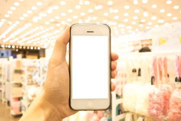 istock Cropped Hand Holding Blank Mobile Phone In Store 1135745106