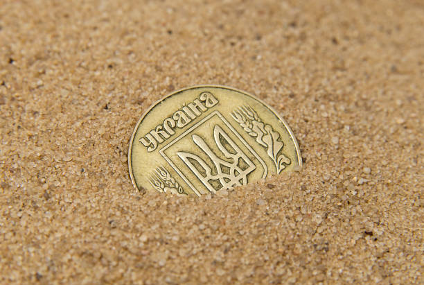 istock Ukrainian bronze coin in the brown sand 1135747151