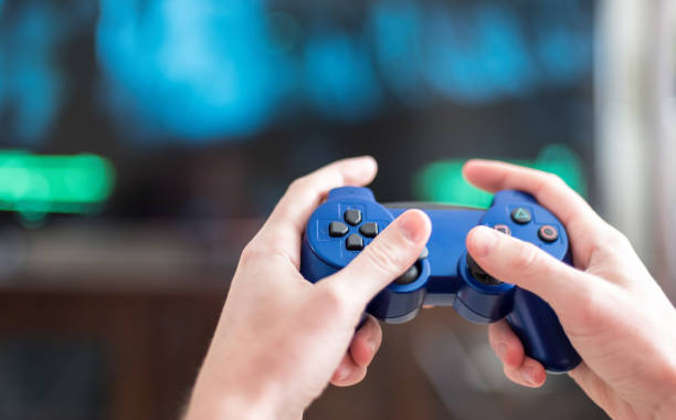 istock Close-Up Of Hands Holding Video Game Remote Control 1135748464
