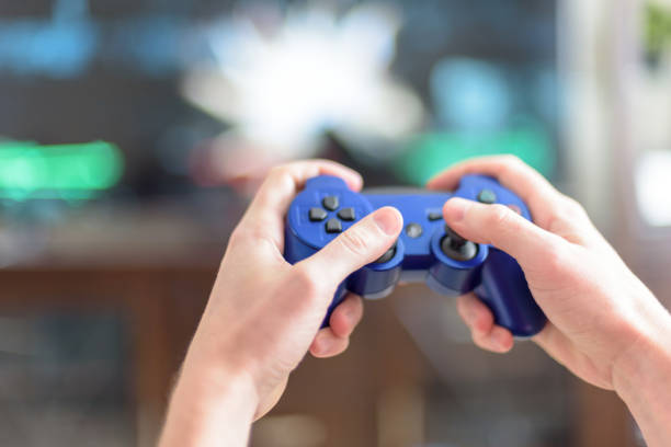 istock Close-Up Of Hands Holding Video Game Remote Control 1135748755