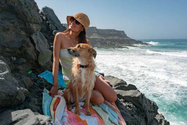 istock girl with her dog on a cliff 1135749063