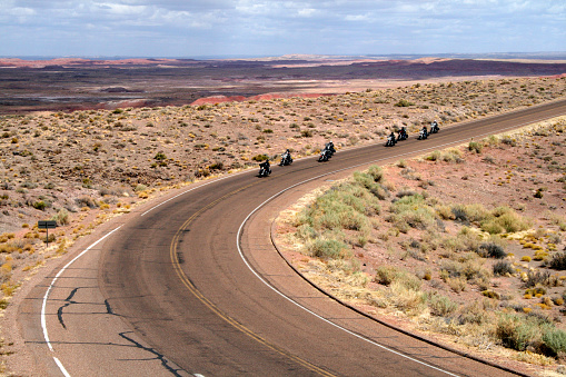 group of bikers  riding through painted desert