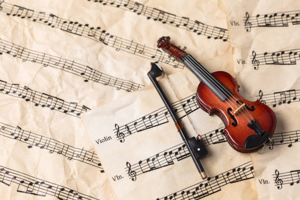 istock Violin on old paper music notes with copy space 1135757242