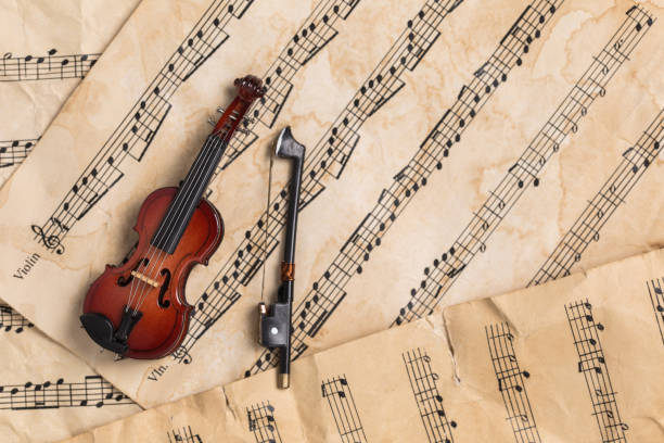 istock Violin on old paper music notes with copy space 1135757536