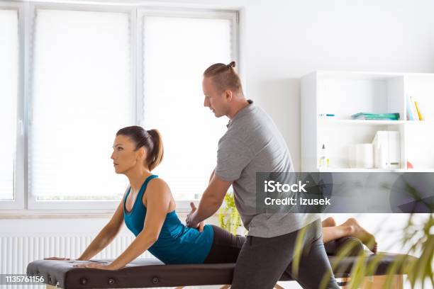 Massage Therapist Massaging Young Woman Stock Photo - Download Image Now - Adult, Adults Only, Alternative Therapy