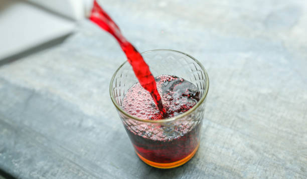 istock pour red drink fruit juice with alcohol in a glass 1135761777