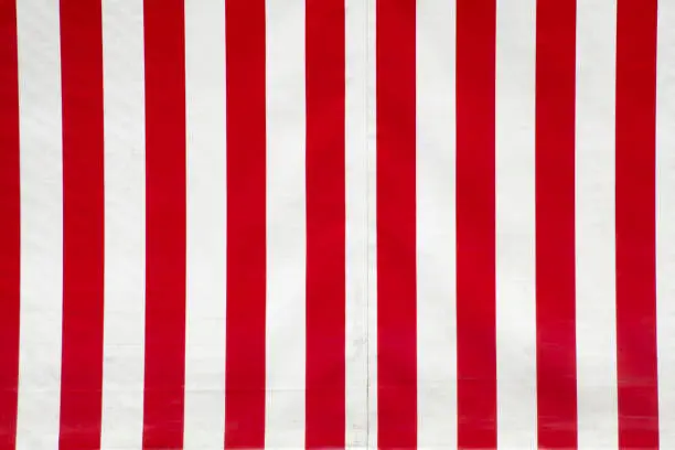 Close up of red and white striped canvas. Full frame horizontal view suitable for background purposes.