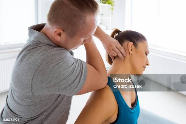 Physiotherapist Massaging Young Woman Stock Photo - Download Image Now - Neck, Massaging, Physical Injury