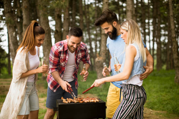 istock Young people enjoying barbecue party in the nature 1135763776