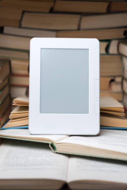 istock Electronic book on background of regular old books 1135763968