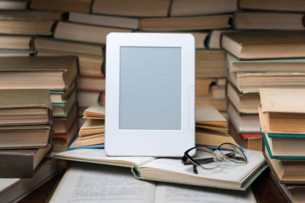 istock Electronic book on background of regular old books 1135763980