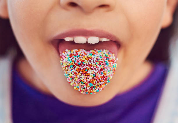 Mixed of colorful candies on yellow background. Smily face