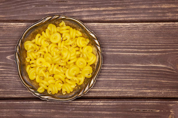 istock Raw pasta funghetto on brown wood 1135764897