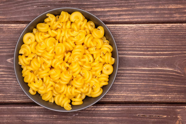 istock Raw pasta funghetto on brown wood 1135764940