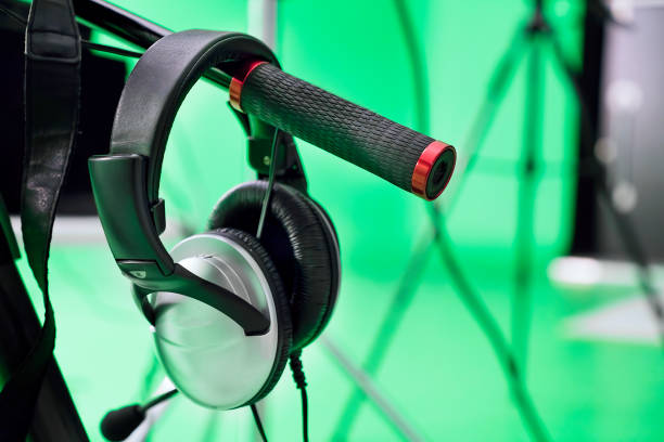 Black headphones isolated from the background lying on the table, large background blur.