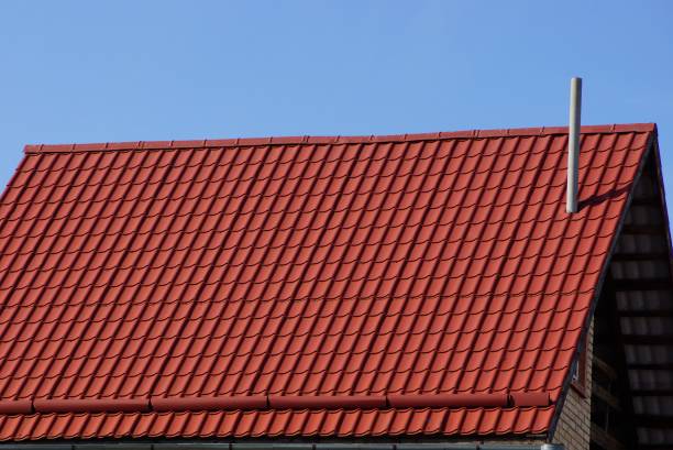 istock red tile roof with chimney against the blue sky 1135765128