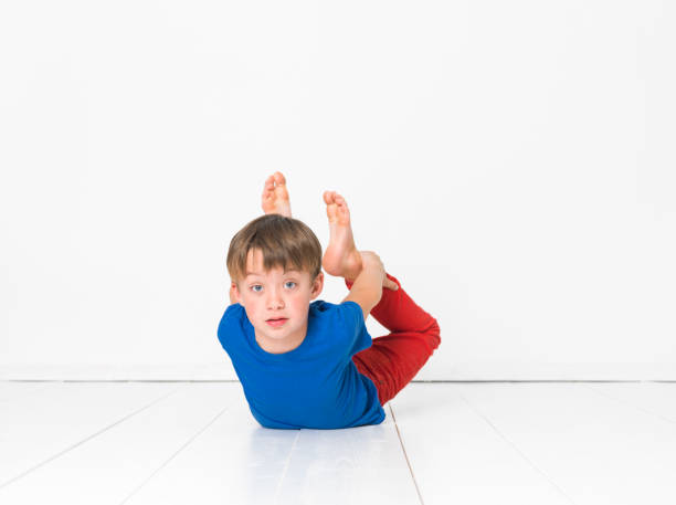 istock cool, six year old boy on white floor 1135765283