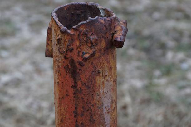 istock part of a long rusty brown pipe on a street pillar 1135765376