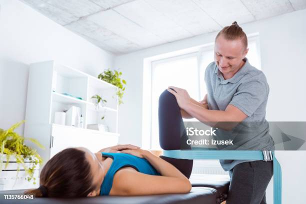 Physiotherapist Massaging Young Woman Stock Photo - Download Image Now - Physical Therapy, Adult, Adults Only