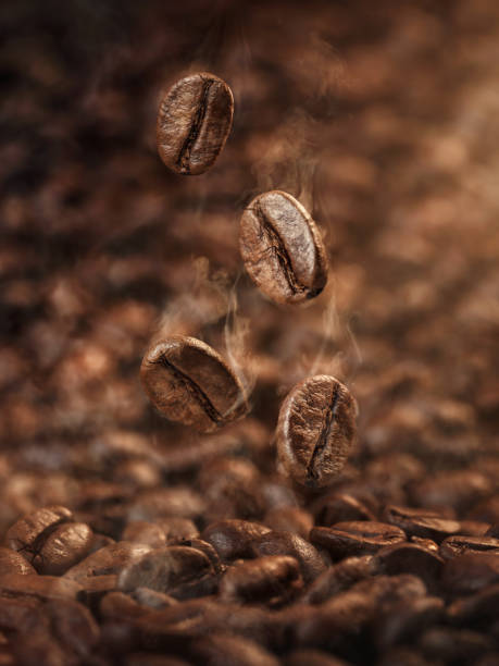roasted coffee beans falling down - falling beans imagens e fotografias de stock