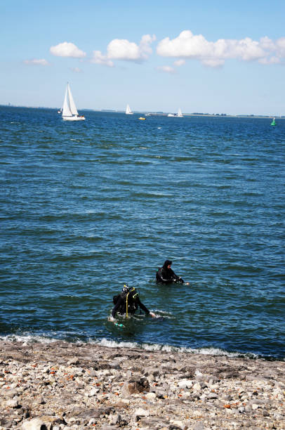 istock Divers checking gear before a dive in the Eastern Scheldt, Zeeland,Netherlands 1135768793